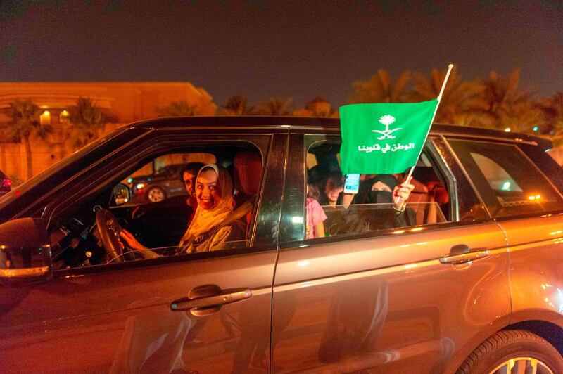 A Saudi woman and her friends celebrate her first time driving on a main street of Khobar City on her way to Kingdom of Bahrain on June 24, 2018. Saudi Arabia will allow women to drive from June 24, ending the world's only ban on female motorists, a historic reform marred by what rights groups call an expanding crackdown on activists. The move, which follows a sweeping crackdown on women activists who long opposed the ban, is part of Crown Prince Mohammed bin Salman's wide-ranging reform drive to modernise the conservative petrostate.

 / AFP / HUSSAIN RADWAN
