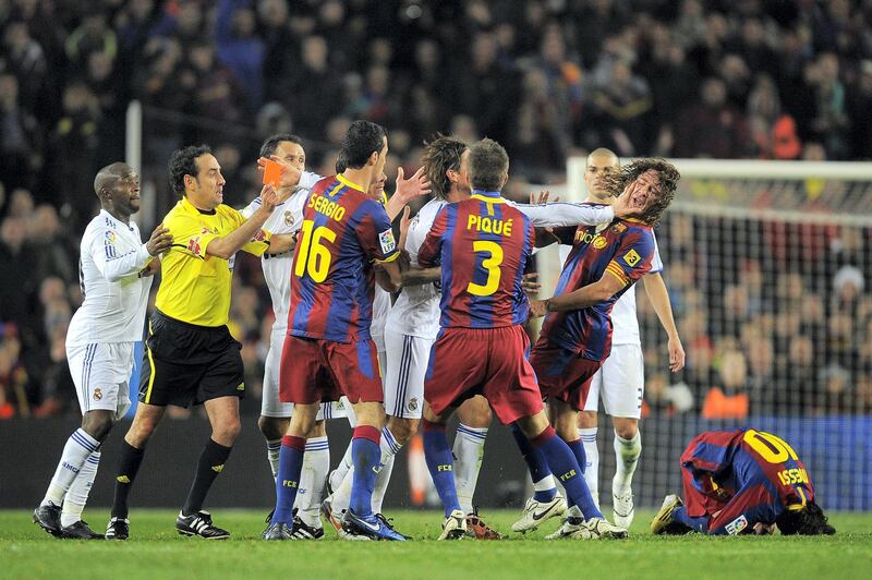 BARCELONA, SPAIN - NOVEMBER 29:  Sergio Ramos of Reral Madrid pushes Carles Puyol's face  (2ndR) during the La Liga match between Barcelona and Real Madrid at the Camp Nou Stadium on November 29, 2010 in Barcelona, Spain.  Barcelona won the match 5-0.  (Photo by David Ramos/Getty Images)