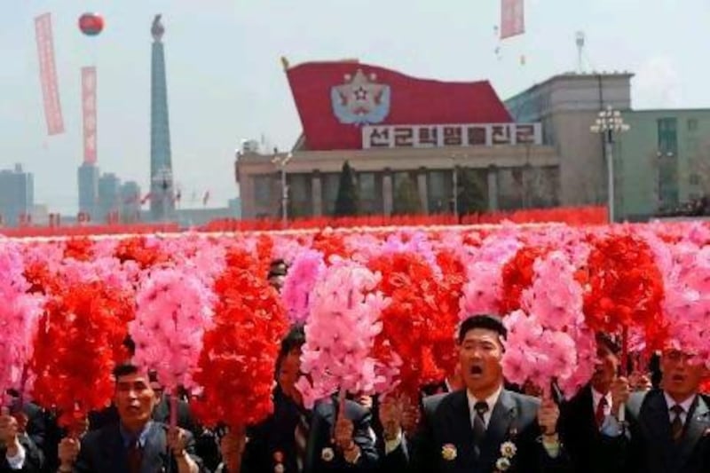 North Koreans react to Kim Jong-un's speech after a military parade marks 100 years since the birth of the country's founder and Jong-un's grandfather, Kim Il-sung, in Pyongyang.