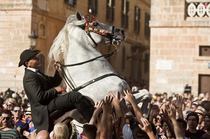 A man in costume rides a horse to the Born Square during Saint John’s Eve celebrations in Ciutadella, Menorca, Balearic Islands. David Arquimbau / EPA