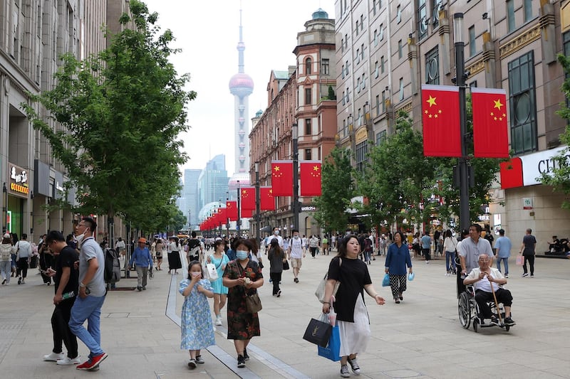 SHANGHAI, CHINA - JUNE 17: Nanjing Road Pedestrian Street is decorated with Chinese national flags to celebrate the 100th anniversary of the founding of the Communist Party of China (CPC) on June 17, 2021 in Shanghai, China. On July 23, 1921, the First National Congress of the Communist Party of China was held in Shanghai. (Photo by Lintao Zhang/Getty Images)