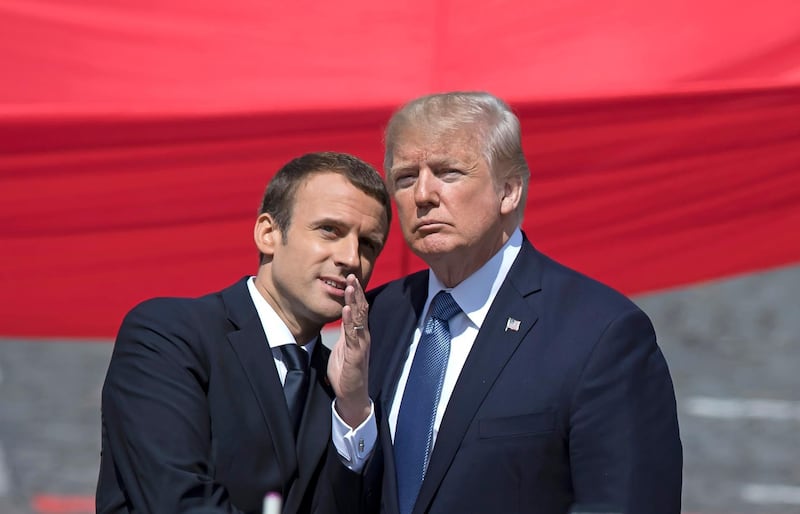 epa06686898 (FILE) - French President Emmanuel Macron (L) talks to US President Donald J. Trump (R)  while attending the traditional military parade as part of the Bastille Day celebrations in Paris, France, 14 July 2017 (reissued 23 April 2018). Macron will head to Washington, DC, USA to meet US President Trump on 23 April 2018.  EPA/IAN LANGSDON