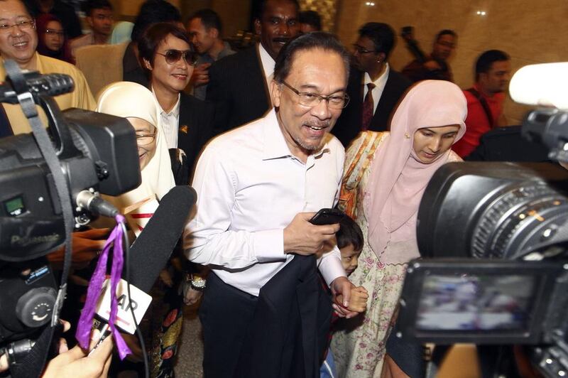 Malaysia's top court on Tuesday upheld the sodomy conviction of opposition leader Anwar Ibrahim, centre, seen here arriving at a court house in Putrajaya, Malaysia. AP Photo MALAYSIA OUT