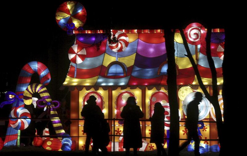 People look on during the Great Lanterns of China light festival in Pakruojis manor, Lithuania. EPA