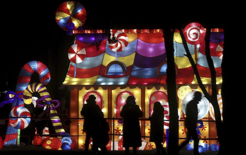 People look on during the Great Lanterns of China light festival in Pakruojis manor, Lithuania. EPA