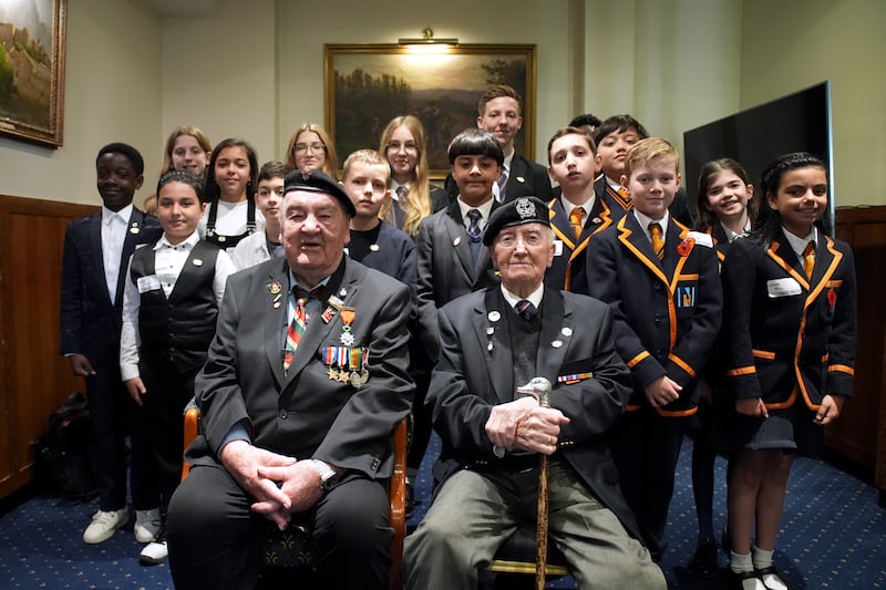 D-Day veterans Richard Aldred, 99, and Stan Ford, 98, meet schoolchildren at the Meet the Veterans: A History Lesson With Those Who Were There event at the Union Jack Club in London. PA