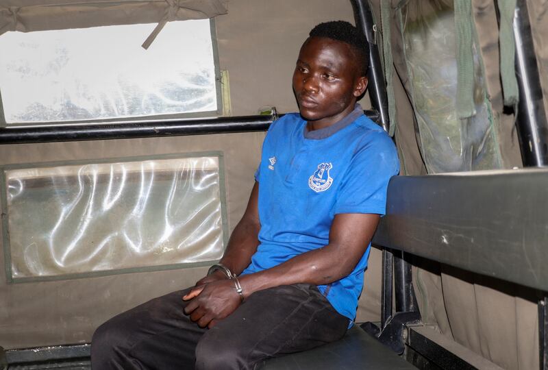 Masten Wanjala in a police vehicle on July 14, 2021. Kenyan police said Wanjala, who reportedly confessed to a string of child murders, was lynched by a mob after escaping from custody. AP Photo