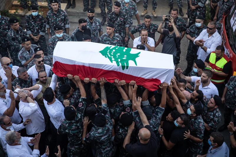 BEIRUT, LEBANON - AUGUST 15:  The coffin of  23-year-old firefighter Ralph Malahi who was killed in the August 4, Beirut port explosion is carried by friends and colleagues from the Karantina Fire department during his funeral on August 15, 2020 in Beirut, Lebanon. The explosion at Beirut's port last week killed over 200 people, injured thousands, and upended countless lives. There has been little visible support from government agencies to help residents clear debris and help the displaced, although scores of volunteers from around Lebanon have descended on the city to help clean. (Photo by Chris McGrath/Getty Images)