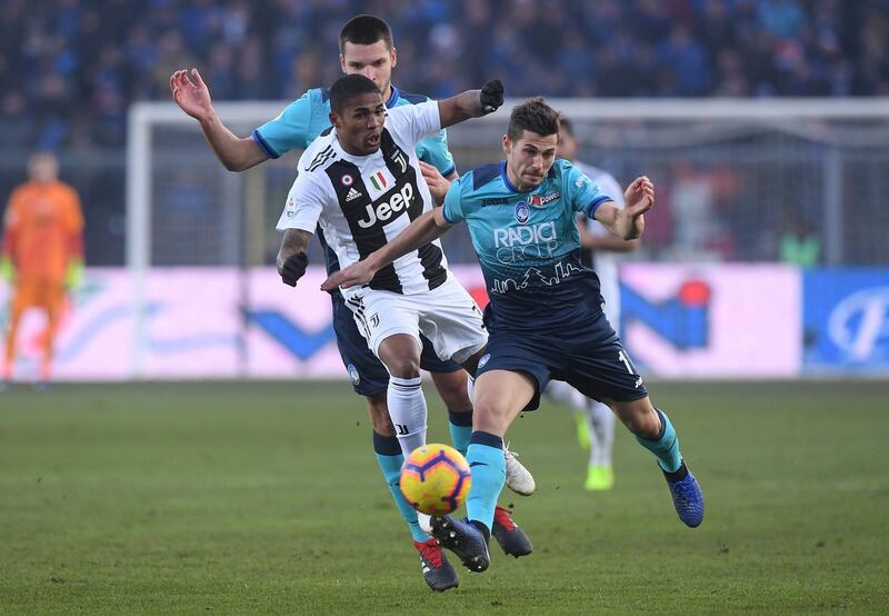 Atalanta's Remo Freuler in action with Juventus' Douglas Costa REUTERS