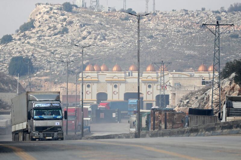 A convoy transporting humanitarian aid crosses into Syria from Turkey through the Bab Al Hawa border crossing. AFP