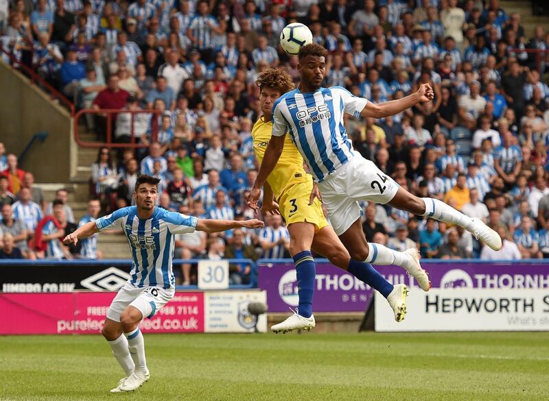 Chelsea's Spanish defender Marcos Alonso, centre, vies with Huddersfield Town's Beninese striker Steve Mounie. AFP