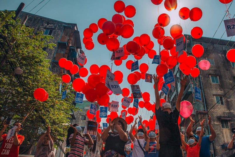 Residents release balloons with messages relating to "R2P", or the "Responsibility to Protect" principle that the international community is justified in taking action against a state that is deemed to have failed to protect its population from atrocities, in Yangon's Hlaing township. AFP