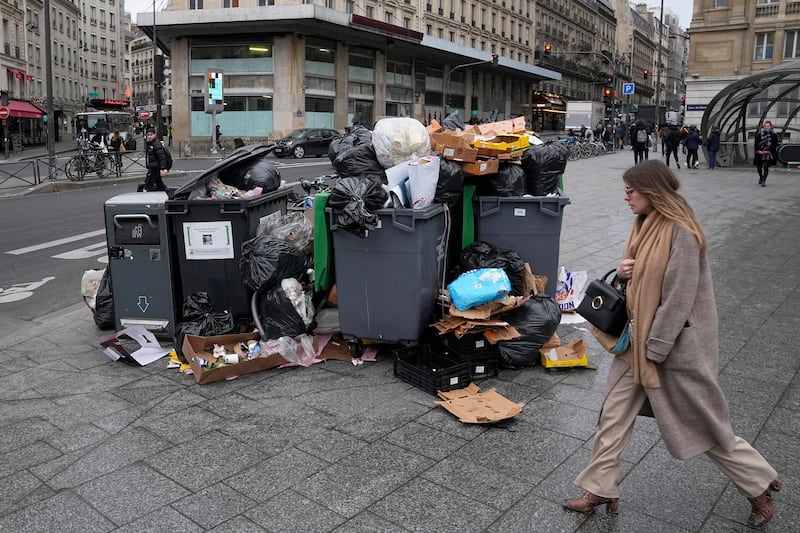 Rubbish piles up on streets as waste treatment workers go on strike. AP