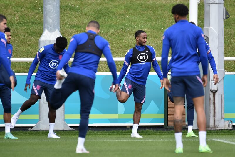 Raheem Sterling and teammates stretch during a training session at St George's Park.