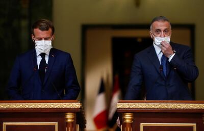 French President Emmanuel Macron and Iraqi Prime Minister Mustafa al-Kadhimi react during a news conference after a meeting, in Baghdad, Iraq September 2, 2020. REUTERS/Gonzalo Fuentes/Pool