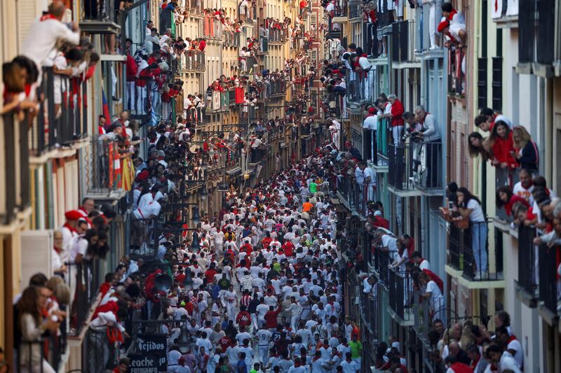 People watch from balconies as revellers take part in the Running of the Bulls event, during the San Fermin festival in Pamplona, Spain. Reuters