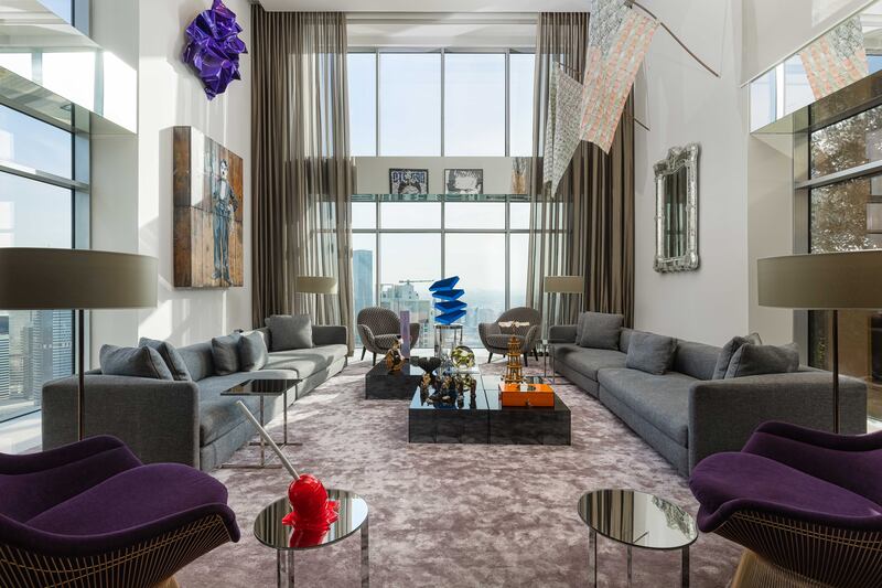 Floor-to-ceiling windows and the double-height ceiling in the living room ensure the apartment is bathed in light.