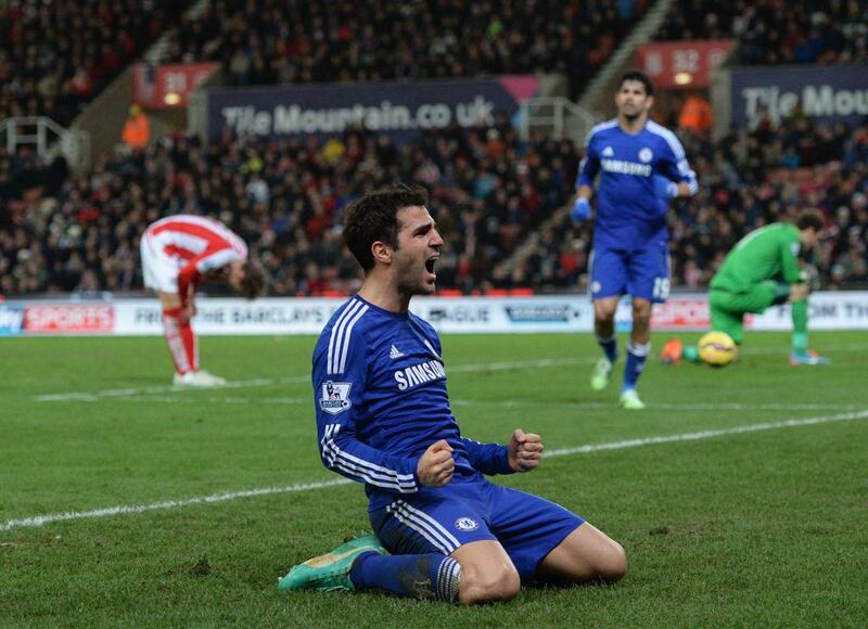 Chelsea’s Spanish midfielder Cesc Fabregas celebrates scoring their second goal during the English Premier League football match between Stoke City and Chelsea at the Britannia Stadium in Stoke-on-Trent, central England, on December 22, 2014. Chelsea won the game 2-0. AFP PHOTO / OLI SCARFF