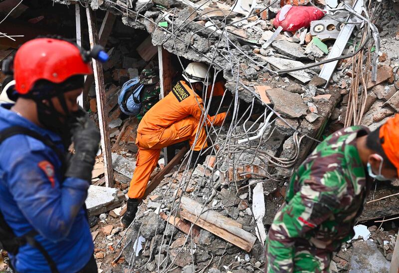 Rescuers search for survivors at a collapsed building in Mamuju city on January 16, 2021, a day after a 6.2-magnitude earthquake rocked Indonesia's Sulawesi island. AFP