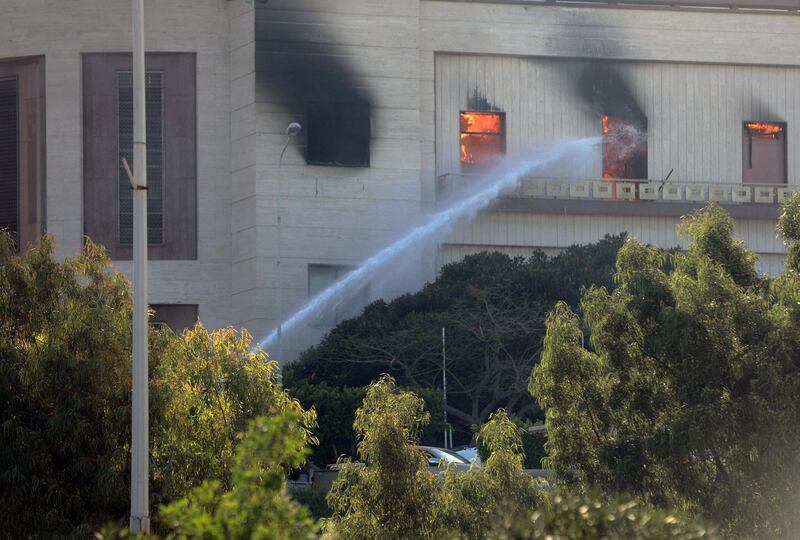 Firemen hose down a burning building of the headquarters of Libya's foreign ministry after suicide attackers hit in Tripoli. Reuters