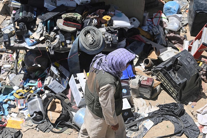 A man selects valuable items at a recycling workshop near the Bagram Air Base. AFP