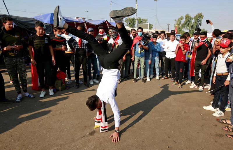 A demonstrator performs a handstand in Najaf. Reuters