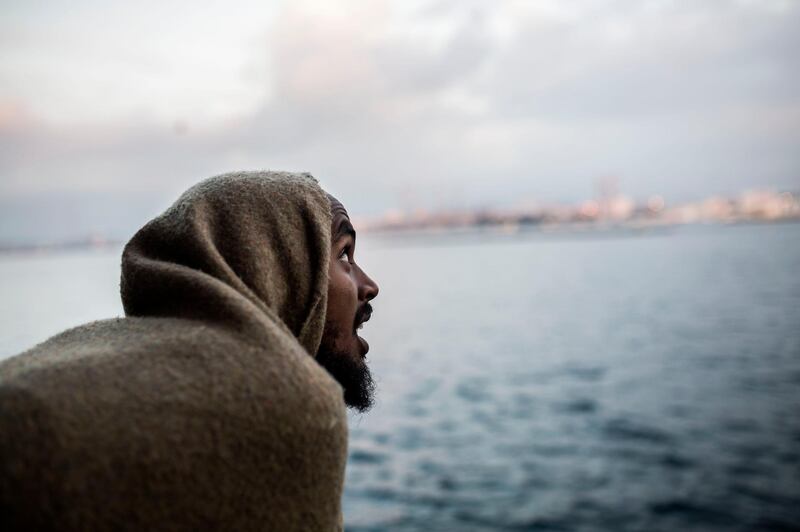 A migrant looks out as they approach port, from the deck of the Spanish NGO Proactiva Open Arms rescue vessel, after being rescued in the Central Mediterranean Sea on Dec. 21 before disembarking in the port of Crinavis in Algeciras, Spain, Friday, Dec. 28, 2018.  To reach Crinavis they have sailed for 6 days with more than 300 migrants on board because other European countries closed their ports to the ship.(AP Photo/Olmo Calvo)