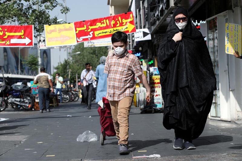 FILE PHOTO: An Iranian woman and her son wearing a protective face mask walks the street, following the outbreak of the coronavirus disease (COVID-19), in Tehran, Iran, June 28, 2020. WANA (West Asia News Agency) via REUTERS ATTENTION EDITORS - THIS PICTURE WAS PROVIDED BY A THIRD PARTY/File Photo