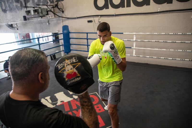 Hamzah Sheeraz hits the pads with trainer Ricky Funez at the Real Boxing Only Gym. Antonie Robertson / The National