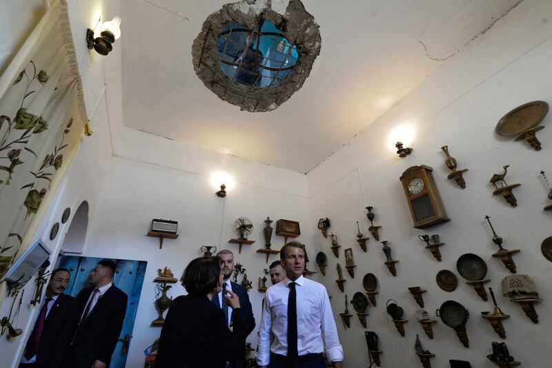 French President Emmanual Macron listens to a guide as he visits the Bytna Institution for Culture, Heritage and Arts, in Iraq's second city of Mosul. AFP