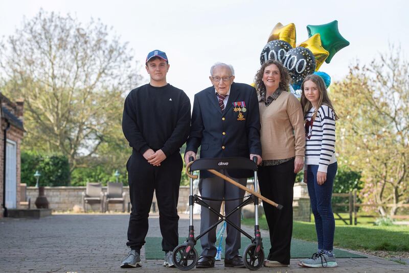 99-year-old war veteran Captain Tom Moore, with (left to right) grandson Benji, daughter Hannah Ingram-Moore and granddaughter Georgia, at his home in Marston Moretaine, Bedfordshire, after he achieved his goal of 100 laps of his garden - raising more than 12 million pounds for the NHS. (Photo by Joe Giddens/PA Images via Getty Images)