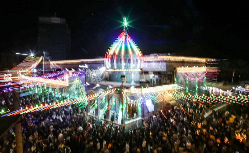 Shiite Muslim pilgrims gather outside the Shrine of Imam Mohammed al-Mahdi during the Shaabaniya ceremony, marking the middle of the Islamic month of Shaban and two weeks before the start of the holy fasting month of Ramadan, and on which Twelver Shiites commemorate the birth of Imam Mahdi (the sect's final Imam), in Iraq's central holy shrine city of Karbala on March 28, 2021.  / AFP / Mohammed SAWAF
