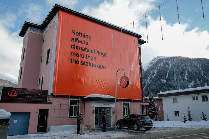 A message about climate change is displayed on an advertising hoarding. Bloomberg