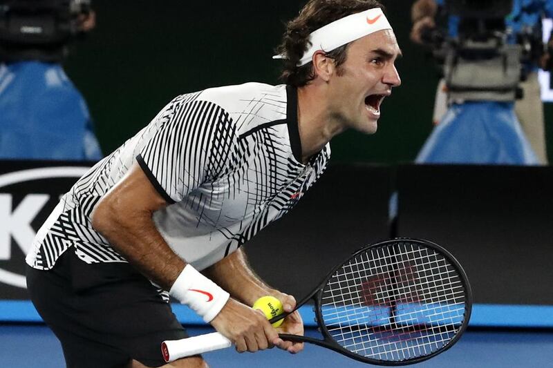 Roger Federer celebrates after winning the Australian Open. Kin Cheung / AP Photo