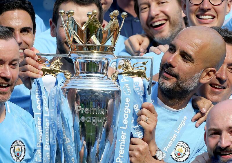 epa06715350 Manchester City's manager Pep Guardiola (R) lifts the Premier League trophy with staff following the English Premier League soccer match between Manchester City and Huddersfield Town at the Etihad Stadium in Manchester, Britain, 06 May 2018.  EPA/NIGEL RODDIS EDITORIAL USE ONLY. No use with unauthorised audio, video, data, fixture lists, club/league logos 'live' services. Online in-match use limited to 75 images, no video emulation. No use in betting, games or single club/league/player publications.