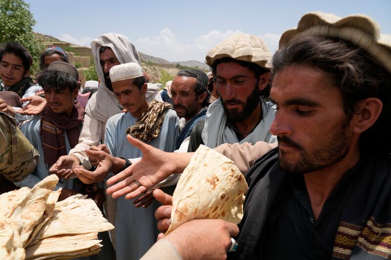 Afghans queue for aid at a camp after an earthquake in Paktika province, Afghanistan, in June. AP