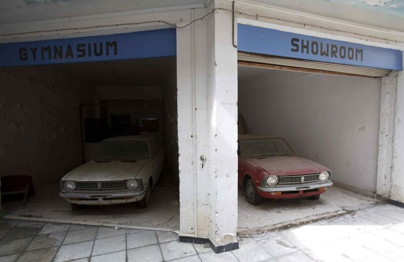 Cars sit abandoned in a former shopping centre.