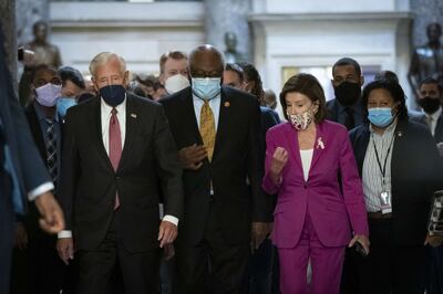House Majority Leader Steny Hoyer, House Majority Whip James Clyburn and Speaker of the House Nancy Pelosi walk to the House Chamber at the US Capitol on Friday. AFP
