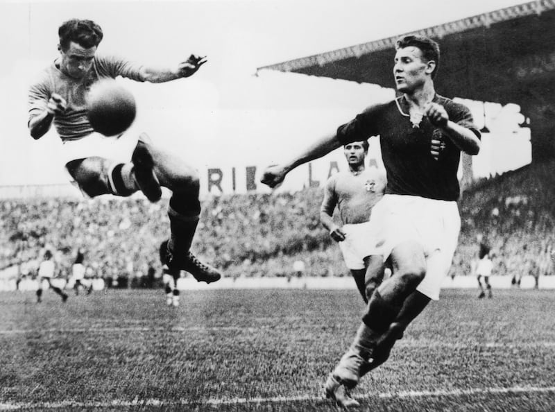 Alfredo Foni, left, of Italy tries in vain to reach a cross during the 1938 World Cup final against Hungary in Paris, France. Italy won the match and trophy 4-2. Getty