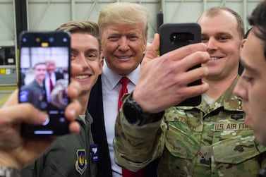 US President Donald Trump poses with American troops based in Ramstein, Germany. The president has in the past threatened to pull US troops out of the European country. AFP / SAUL LOEB