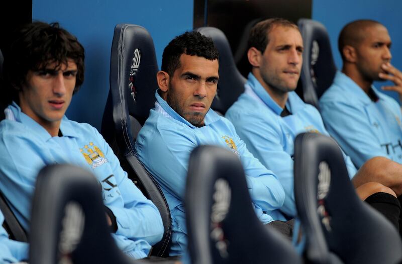 BOLTON, ENGLAND - AUGUST 21:  Carlos Tevez of Manchester City (2nd on L) watches from the bench during the Barclays Premier League match between Bolton Wanderers and Manchester City at the Reebok Stadium on August 21, 2011 in Bolton, England.  (Photo by Michael Regan/Getty Images) *** Local Caption ***  121653920.jpg