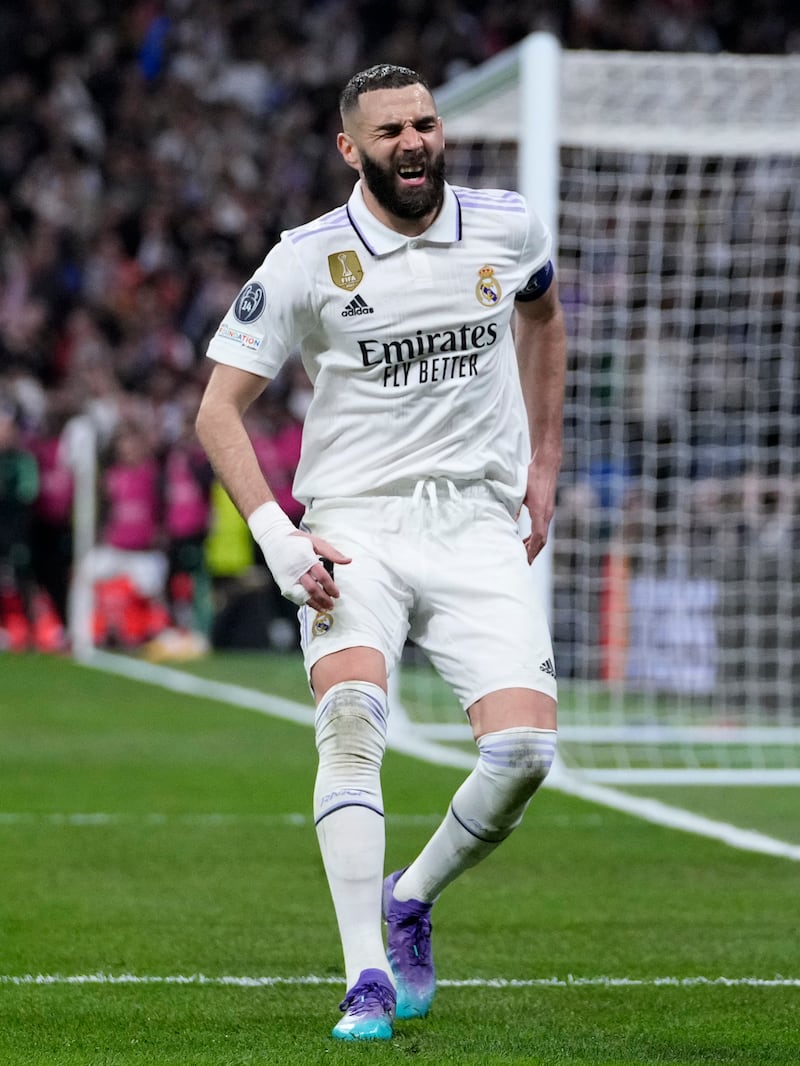 Karim Benzema grimaces while celebrating scoring. AP