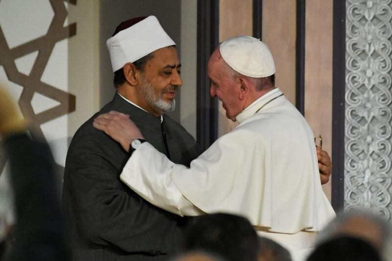 Pope Francis (R) and Sheikh Ahmed Al Tayeb, the Grand Imam of Al Azhar, embrace as the Pope arrives at the prestigious Sunni institution in Cairo on April 28, 2017. Andreas Solaro / AFP

