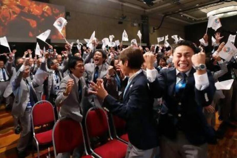 Members of the Japanese bid committee celebrate as Jacques Rogge, president of the International Olympic Committee announces Tokyo as the city to host the 2020 Summer Olympic Games.