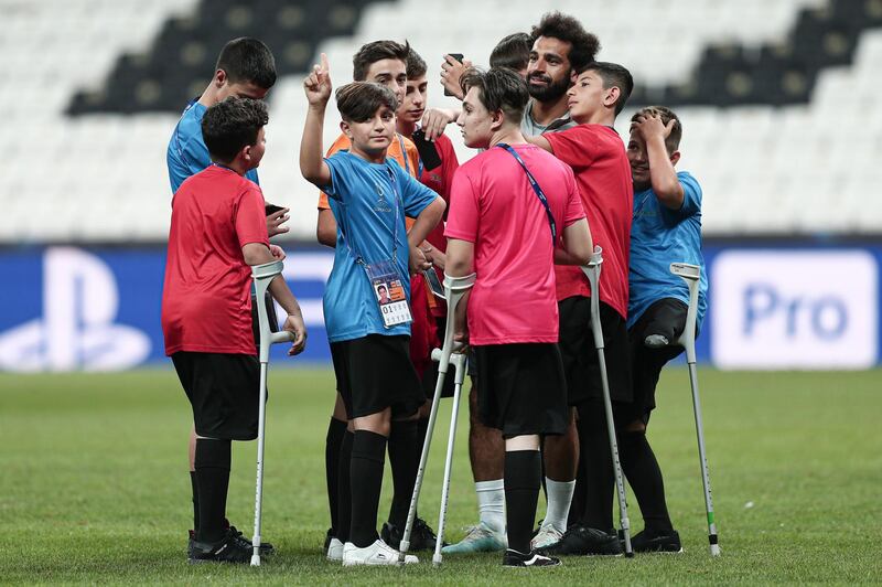 Disabled children join Liverpool's Mohamed Salah during a training session of Liverpool FC in Istanbul, Turkey.  EPA