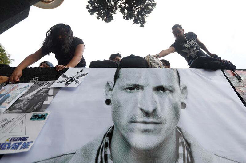 Fans stick posters as they gather at Revolucion monument to pay tribute to Chester Bennington, Linkin Park frontman, following the singer's death by suicide, in Mexico City, Mexico, July 23, 2017. REUTERS/Edgard Garrido NO RESALES. NO ARCHIVES.
