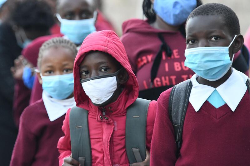Kenyan school children wear face masks while walking to school as they resume in-class learning after a nine-month disruption caused by the pandemic, in Nairobi on January 4. AFP