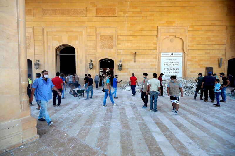 People clean debris at Mohammed Al Amin mosque in the centre of Beirut. AFP