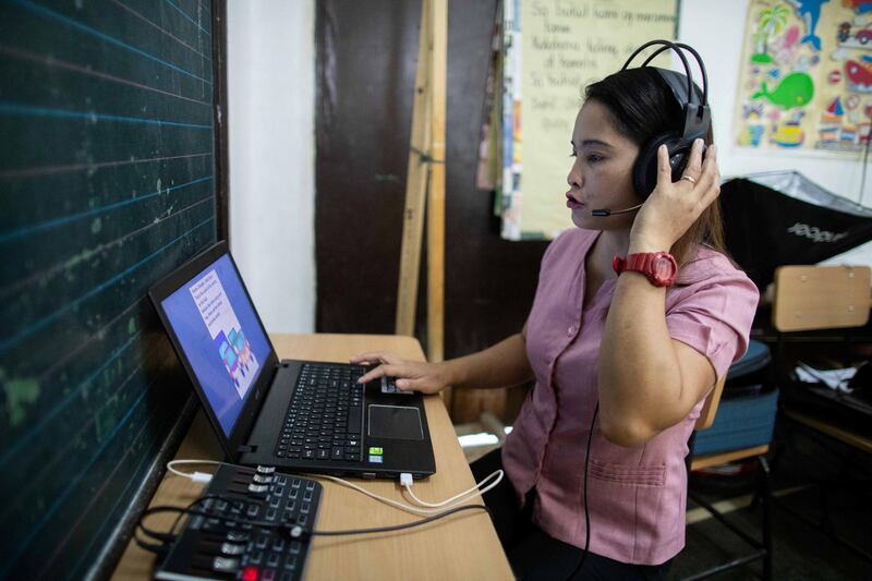 An elementary teacher records her voice, reading a storybook as the education department copes with distance learning amid the coronavirus disease (COVID-19) in Navotas, Metro Manila, Philippines. REUTERS