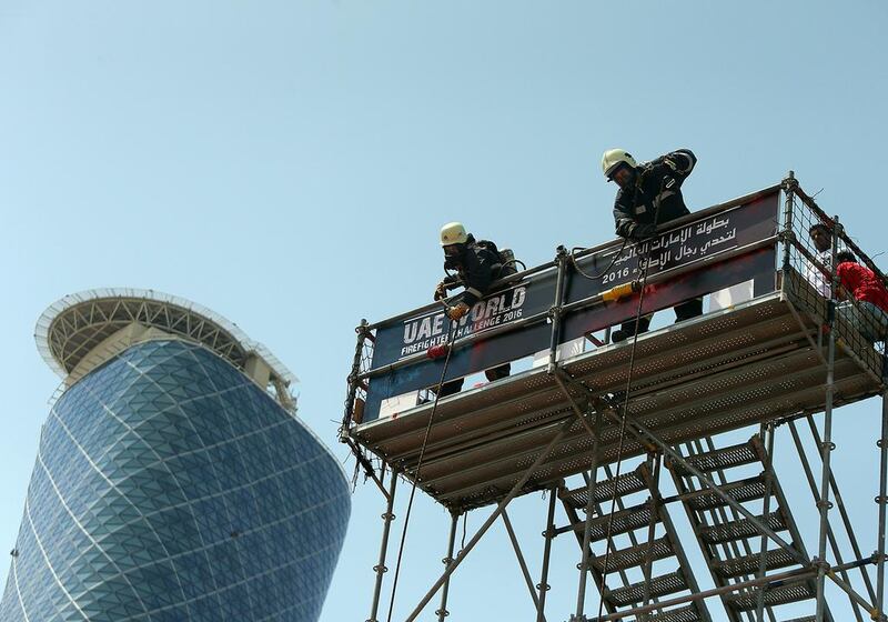 Competitors climb six storeys carrying a 20-kilogram hose and, from the top, hoist another 20kg hose all the way from the ground. Satish Kumar / The National